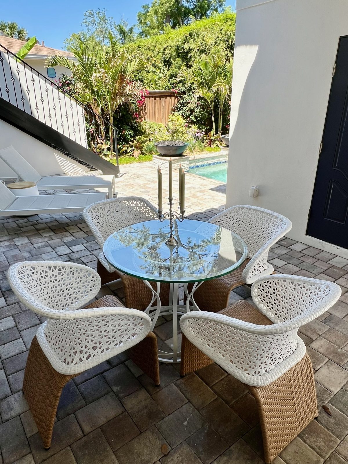 Poolside dining set on a brick paver deck