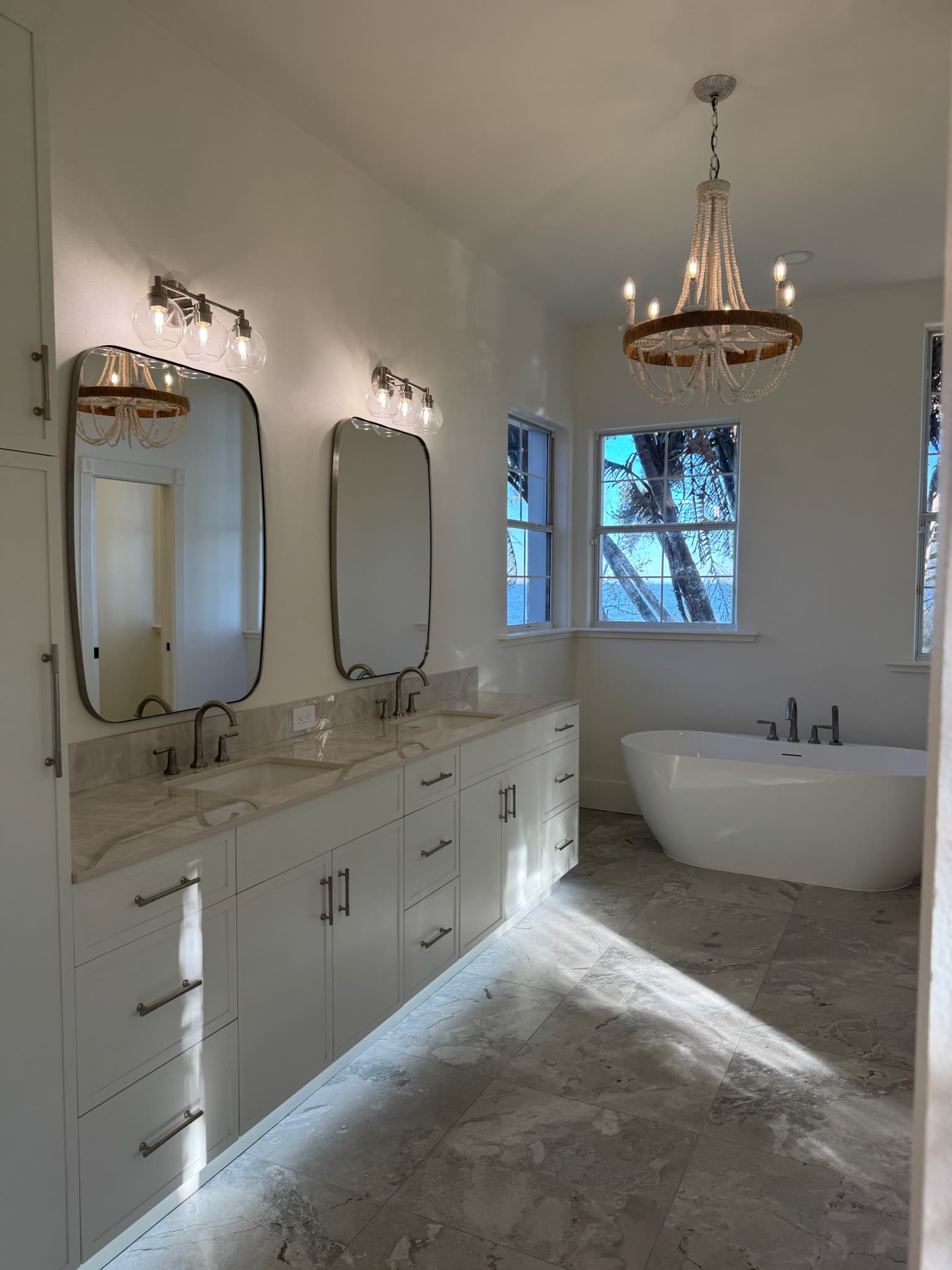 Primary bath with freestanding tub and dual vanities