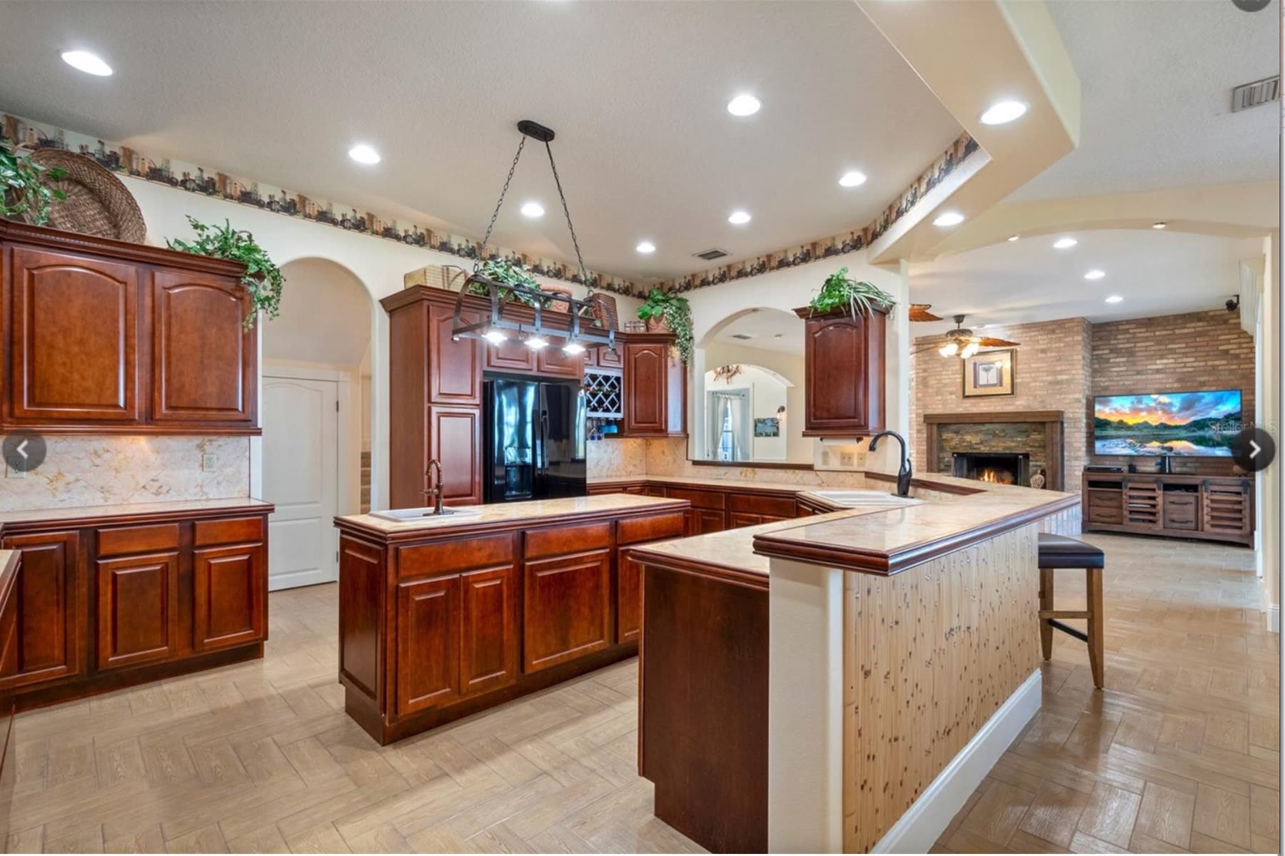 Dark cherry cabinetry and tile counters before renovation