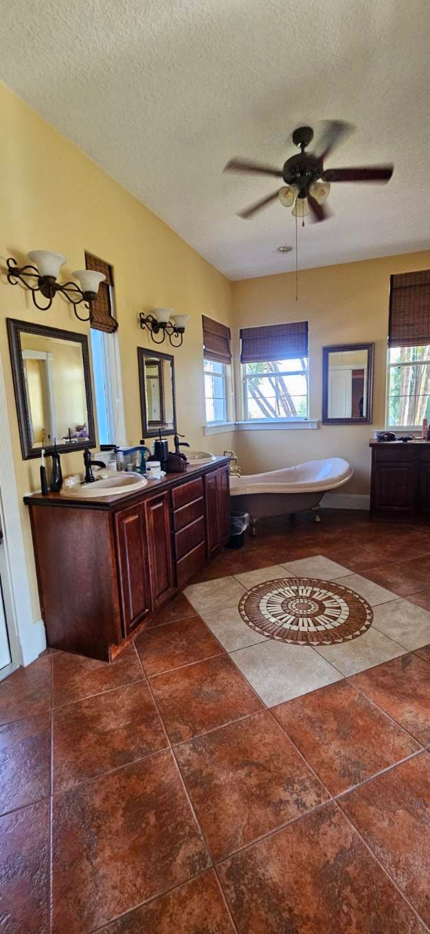 Primary bath with dated tile and a drop-in tub before renovation