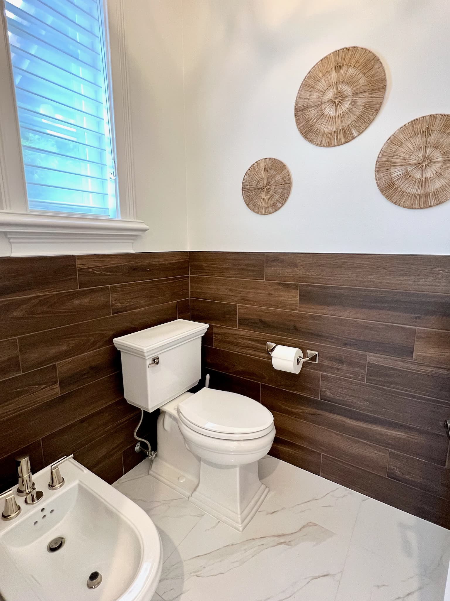 Powder room with horizontal walnut plank wall