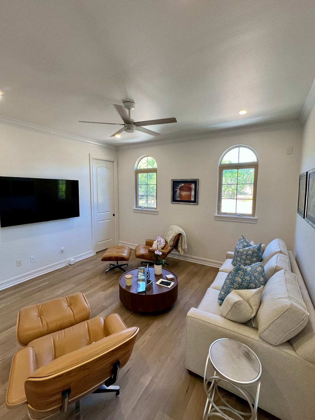 Remodeled living room with arched windows and white oak flooring