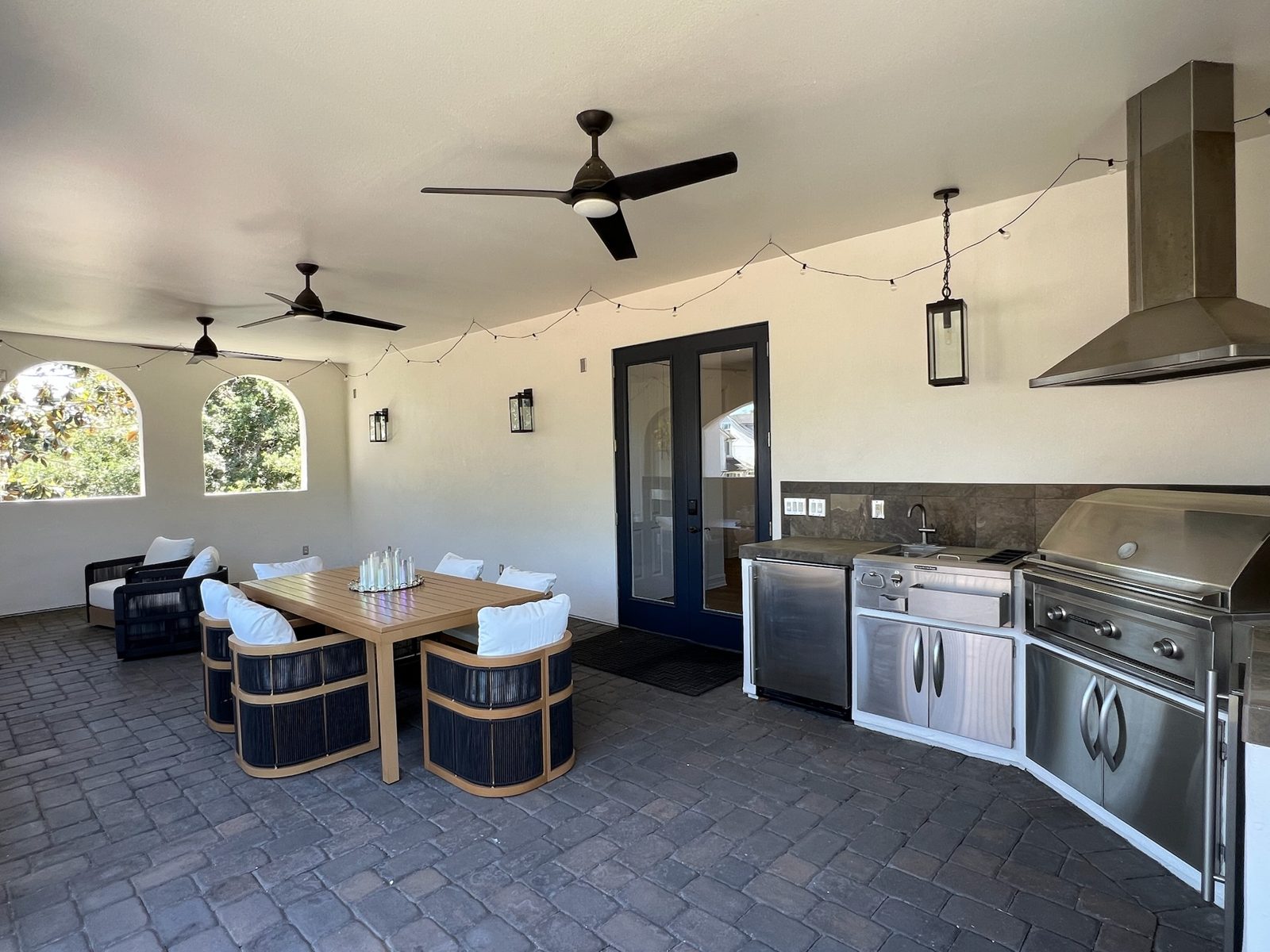 Covered lanai with outdoor kitchen and dining area
